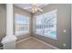 Bright sitting area features tile floors and multiple windows with views of the backyard at 2930 Swan Cir, Dunedin, FL 34698