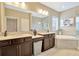 Spa-like bathroom with double vanity and soaking tub at 29762 Chapel Chase Dr, Wesley Chapel, FL 33545