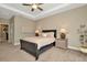 Comfortable bedroom with a dark-brown sleigh bed, two nightstands, and neutral wall colors at 29762 Chapel Chase Dr, Wesley Chapel, FL 33545
