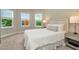 Bright bedroom with a queen-size bed and neutral decor at 29762 Chapel Chase Dr, Wesley Chapel, FL 33545