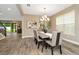 Elegant dining room with a large table, six chairs, and a modern chandelier at 29762 Chapel Chase Dr, Wesley Chapel, FL 33545