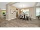 Spacious dining room with a large table and chairs, offering views of the kitchen and living room at 29762 Chapel Chase Dr, Wesley Chapel, FL 33545
