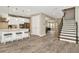 Open concept kitchen and living area with wood-look tile floors at 29762 Chapel Chase Dr, Wesley Chapel, FL 33545