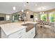 Kitchen island with farmhouse sink, white cabinets and breakfast nook at 29762 Chapel Chase Dr, Wesley Chapel, FL 33545