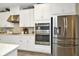 Modern kitchen boasts stainless steel appliances and white cabinetry at 29762 Chapel Chase Dr, Wesley Chapel, FL 33545