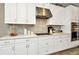 Modern kitchen with white cabinets, stainless steel appliances, and quartz countertops at 29762 Chapel Chase Dr, Wesley Chapel, FL 33545