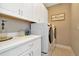 Bright laundry room with white cabinets and washer/dryer at 29762 Chapel Chase Dr, Wesley Chapel, FL 33545