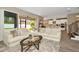 Spacious living room with beige sofas and a large glass-top coffee table, leading to the backyard at 29762 Chapel Chase Dr, Wesley Chapel, FL 33545