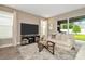 Living room with beige sofa and sliding glass doors leading to backyard at 29762 Chapel Chase Dr, Wesley Chapel, FL 33545