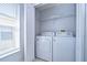 Bright laundry room with washer, dryer, and window at 31342 Philmar Ln, Wesley Chapel, FL 33543