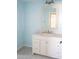 Bathroom with light blue walls, white vanity, and marble countertop at 317 Green Manor Dr # 38 B, Sun City Center, FL 33573