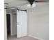 Bedroom with barn door and ceiling fan at 317 Green Manor Dr # 38 B, Sun City Center, FL 33573