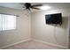 Bright bedroom with wall-mounted TV and ceiling fan at 317 Green Manor Dr # 38 B, Sun City Center, FL 33573