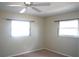 Bright bedroom with carpeted floor, ceiling fan, and two windows at 317 Green Manor Dr # 38 B, Sun City Center, FL 33573