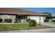 Well-maintained house with a landscaped lawn, attached garage, and attractive curb appeal at 317 Green Manor Dr # 38 B, Sun City Center, FL 33573