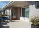 Front entrance with covered patio, seating area, and decorative door at 317 Green Manor Dr # 38 B, Sun City Center, FL 33573