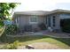 Exterior view showing the back of the house with landscaping at 317 Green Manor Dr # 38 B, Sun City Center, FL 33573