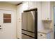 Stainless steel refrigerator and white kitchen cabinets at 317 Green Manor Dr # 38 B, Sun City Center, FL 33573