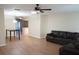 Open living area with hardwood floors, leather couch, and view into dining area at 317 Green Manor Dr # 38 B, Sun City Center, FL 33573