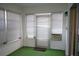 Sunroom features window blinds, an AC unit, and green carpeting at 317 Green Manor Dr # 38 B, Sun City Center, FL 33573