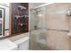 Clean bathroom with glass shower, mosaic tile, and wood shelving at 3628 Holiday Lake Dr, Holiday, FL 34691