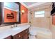 Bathroom with marble vanity, large mirror, and a bathtub at 3628 Holiday Lake Dr, Holiday, FL 34691