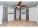Spacious bedroom with hardwood floors and gray curtains at 3628 Holiday Lake Dr, Holiday, FL 34691