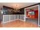 Elegant dining area with hardwood floors and a modern chandelier at 3628 Holiday Lake Dr, Holiday, FL 34691
