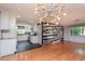 Open dining area with hardwood floors, chandelier, and kitchen view at 3628 Holiday Lake Dr, Holiday, FL 34691