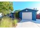 Charming blue house with a star detail, landscaping, and attached garage at 3628 Holiday Lake Dr, Holiday, FL 34691
