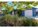 Cute blue house with a well-maintained lawn and attached garage at 3628 Holiday Lake Dr, Holiday, FL 34691