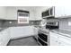 Modern kitchen featuring stainless steel appliances and granite countertops at 3628 Holiday Lake Dr, Holiday, FL 34691