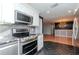 Updated kitchen with stainless steel appliances and a view of the dining area at 3628 Holiday Lake Dr, Holiday, FL 34691