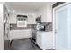 Modern kitchen with white cabinets, granite counters, and dark flooring at 3628 Holiday Lake Dr, Holiday, FL 34691