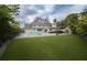 Large backyard with a pool, hot tub, and artificial grass at 414 S Shore Crest Dr, Tampa, FL 33609