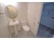 Clean bathroom featuring a toilet, sink, and access to laundry at 414 S Shore Crest Dr, Tampa, FL 33609