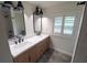 Modern bathroom with double vanity, black matte fixtures, and hexagon tile floor at 414 S Shore Crest Dr, Tampa, FL 33609