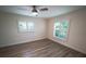 Spacious bedroom with wood flooring, ceiling fan, and window shutters at 414 S Shore Crest Dr, Tampa, FL 33609