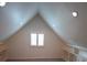 Bonus room with vaulted ceiling, built-in shelving, and window with shutters at 414 S Shore Crest Dr, Tampa, FL 33609