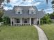 Two-story house with gray roof, white siding, and landscaped yard at 414 S Shore Crest Dr, Tampa, FL 33609