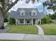 Two-story house with gray roof, white siding, and landscaped yard at 414 S Shore Crest Dr, Tampa, FL 33609