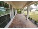 Brick-paved porch with white columns and lush landscaping at 414 S Shore Crest Dr, Tampa, FL 33609