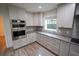 Modern kitchen with white cabinets, gray countertops and gold hardware at 414 S Shore Crest Dr, Tampa, FL 33609