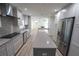 Open concept kitchen with island, stainless steel appliances, and view into living room at 414 S Shore Crest Dr, Tampa, FL 33609
