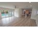 Open living room with pool view, hardwood floors, and an open concept kitchen at 414 S Shore Crest Dr, Tampa, FL 33609