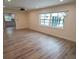 Spacious living room with wood-look floors and a view into the kitchen at 414 S Shore Crest Dr, Tampa, FL 33609