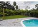 Relaxing backyard with a refreshing blue pool and artificial turf at 414 S Shore Crest Dr, Tampa, FL 33609
