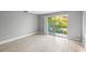 Bedroom with wood-look floors and sliding doors to balcony at 4215 E Bay Dr # 1105C, Clearwater, FL 33764