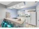 Updated kitchen with white cabinets, granite counters and tile backsplash at 4215 E Bay Dr # 1105C, Clearwater, FL 33764