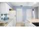 Kitchen boasts white cabinets, granite counters and stylish tile backsplash at 4215 E Bay Dr # 1105C, Clearwater, FL 33764